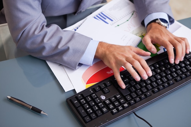 Businessman's hands typing on keyboard