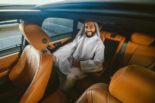 Businessman A saudi businessman in traditional clothing in a car