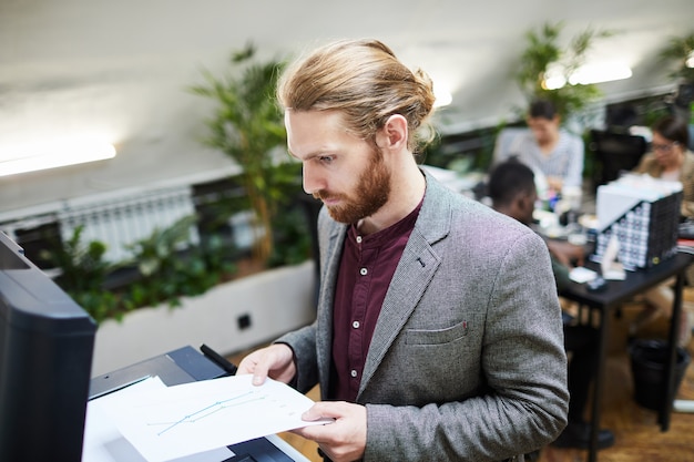 Businessman Scanning Documents in Office