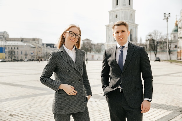 The businessman and the secretary walk along the city streets during a break from work