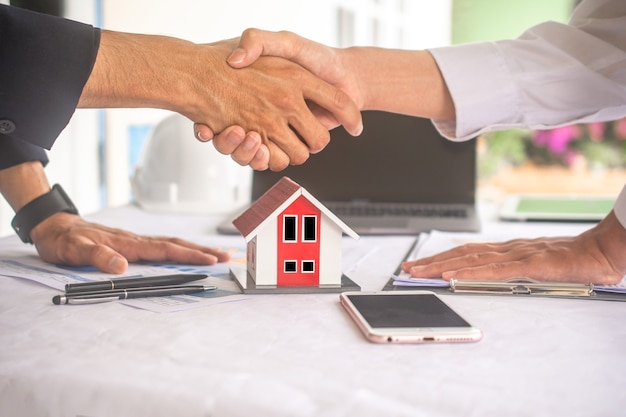 Businessman shake hand agreement for sale contract house success