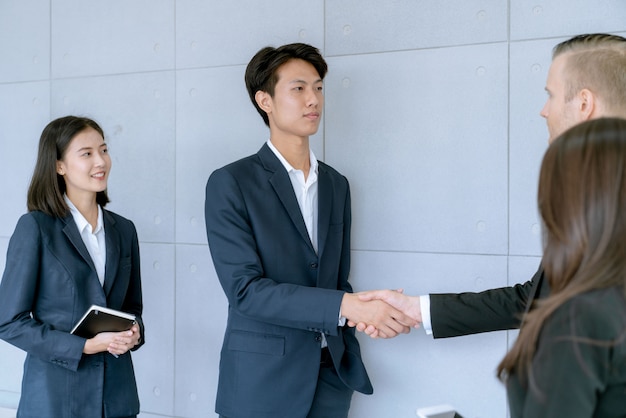 Businessman shake hands agree deal of big lot sales that finish goal of marketing plans of the company