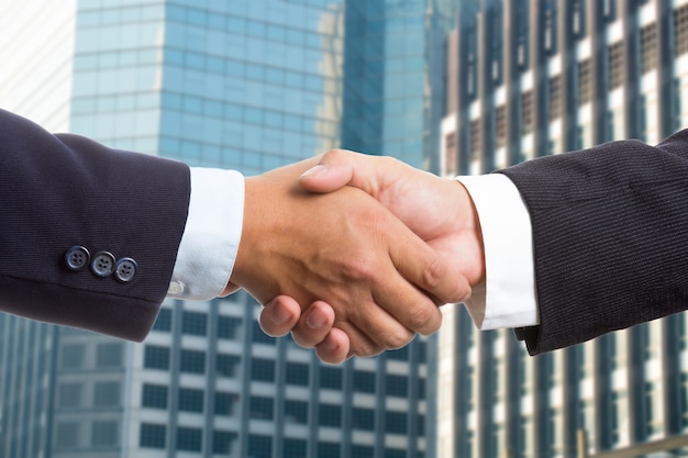 Businessman shake hands for deal thier business.