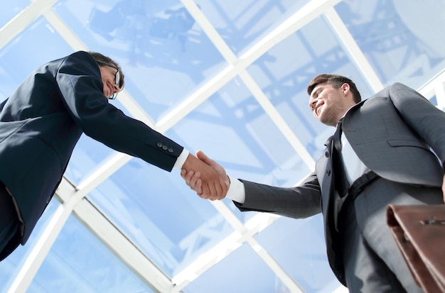 Businessman shaking hand to her partner