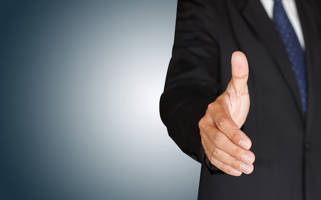 Businessman shaking hands on blue background