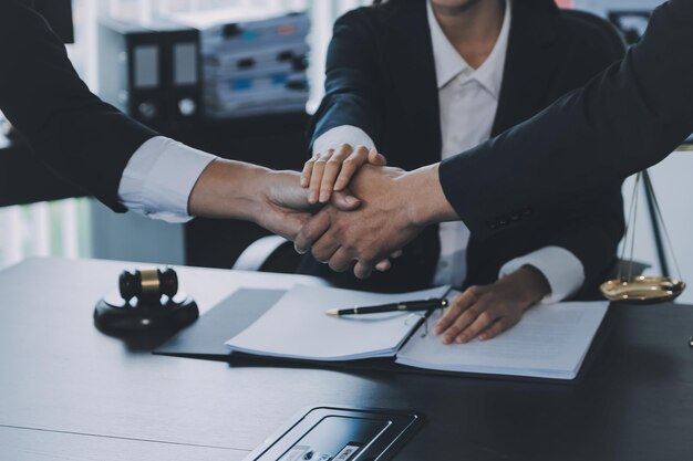 Businessman shaking hands to seal a deal with his partner lawyers or attorneys discussing a contract agreement