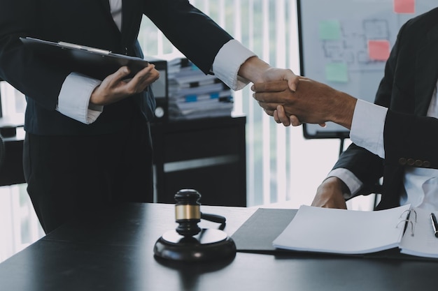 Businessman shaking hands to seal a deal with his partner lawyers or attorneys discussing a contract agreement