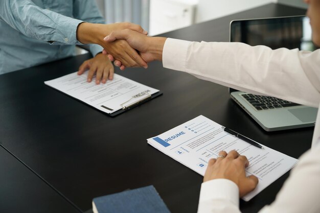 Photo businessman shaking hands successful candidate at interview got the job in the team welcome aboard successful making a dealxapartnership meeting concept