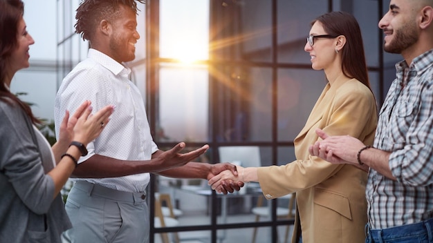 Businessman shaking hands with colleague after meeting in office