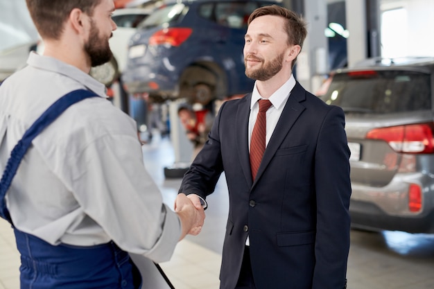 Businessman Shaking Hands with Mechanic