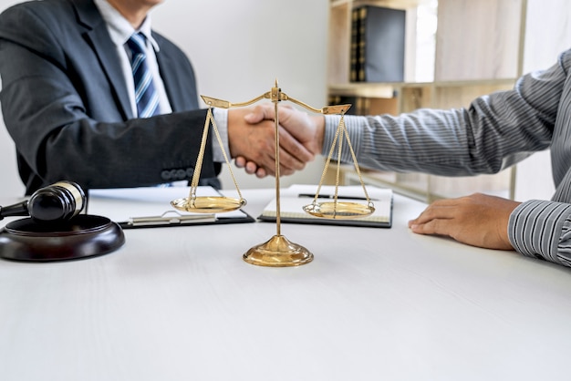 Businessman shaking hands with professional lawyer after discussing good deal