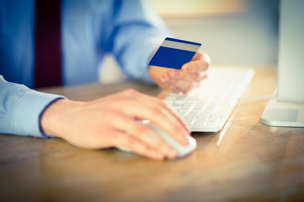 Businessman shopping online at desk