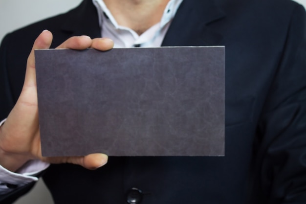 Businessman showing blank signboard