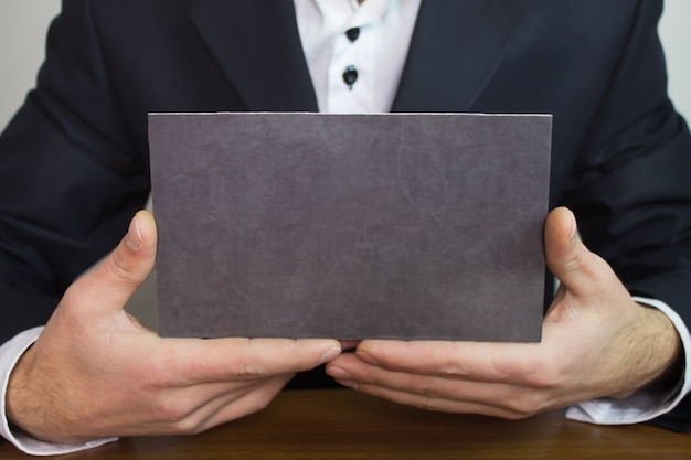 Businessman showing blank signboard