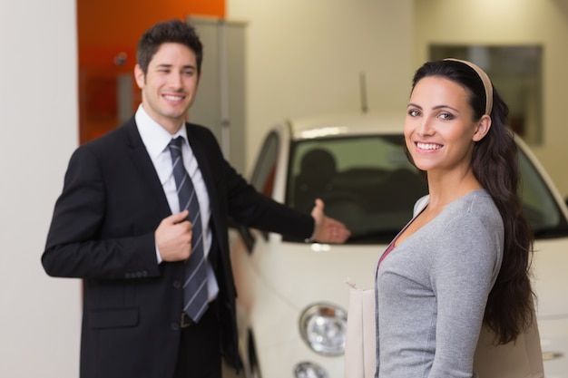 Businessman showing a car to a woman