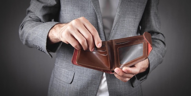 Businessman showing empty wallet. Bankruptcy