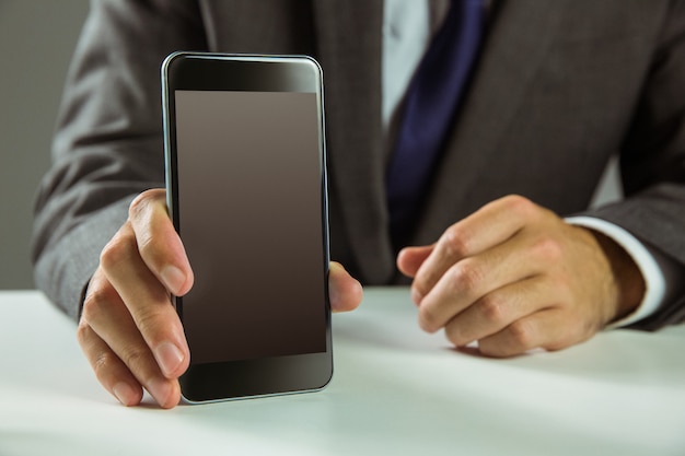 Businessman showing his smart phone