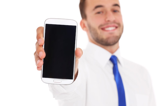 a businessman showing his smartphone over white background