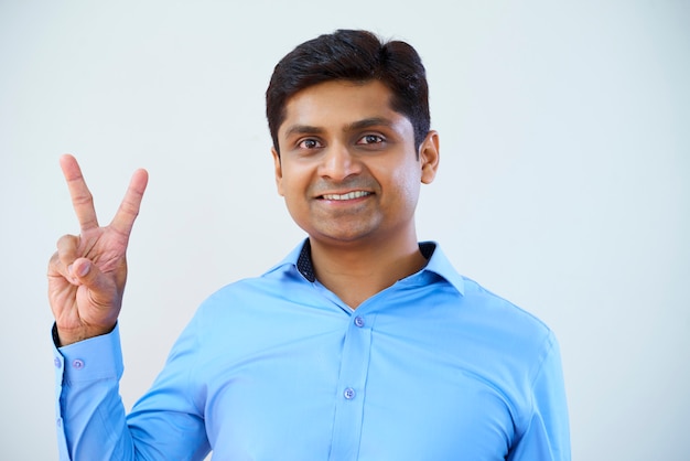 Businessman showing peace sign