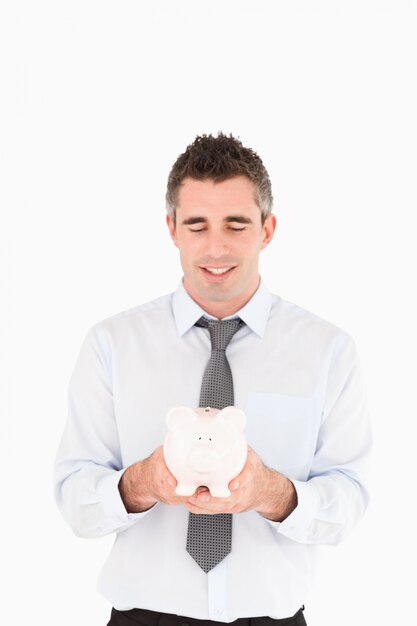 Businessman showing a piggy bank