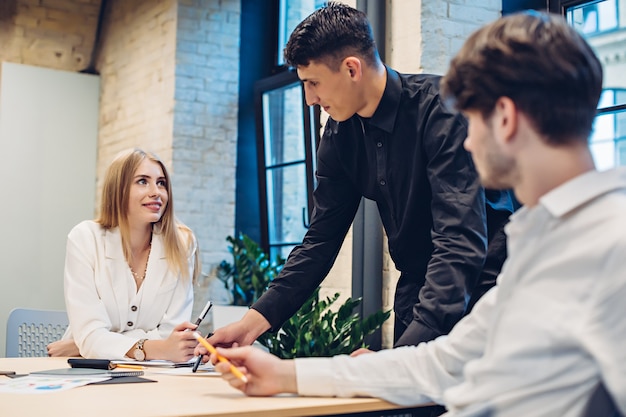 Businessman showing something to colleagues