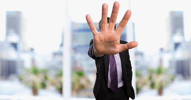 Businessman showing stop gesture in city