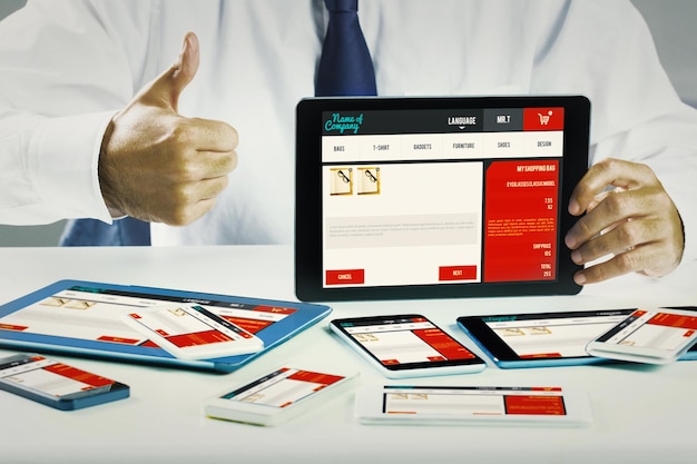Businessman showing tablet pc  against website design