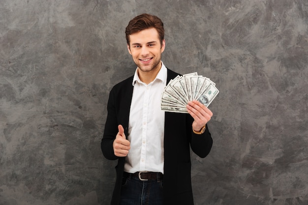 Businessman showing thumbs up gesture.