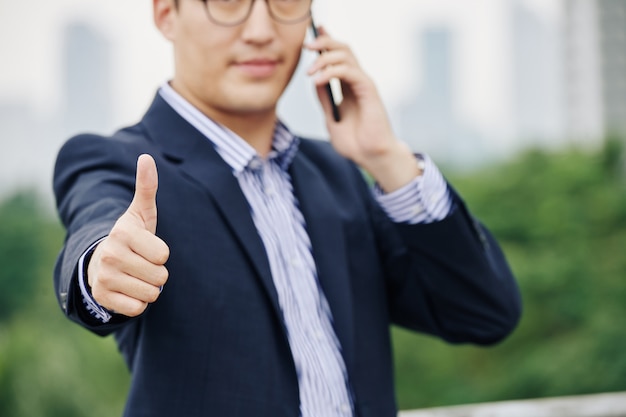 Businessman showing thumbs-up
