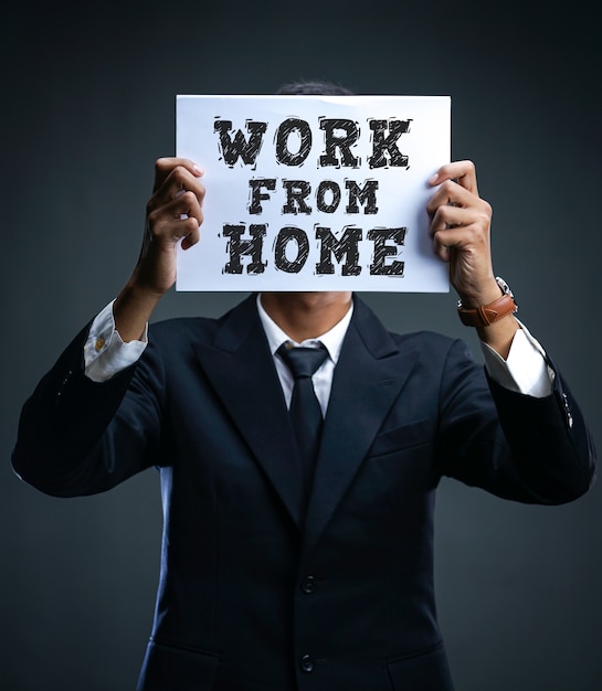 Businessman showing Work From Home sign