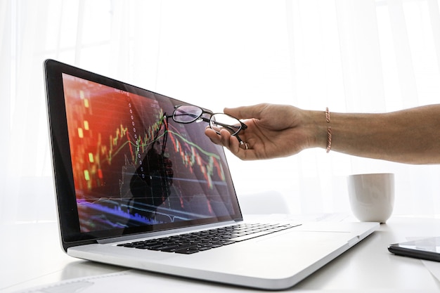 Businessman shows the screen on laptop the graph of growth