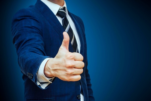 Businessman shows thumb up sign gesture nonverbal communication