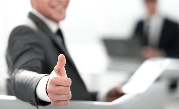 Businessman shows thumb up