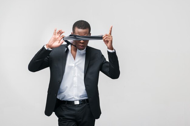 Businessman shutting his eyes with tie