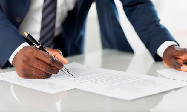 businessman signing a business document with a pen