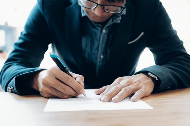 Businessman signing contract making a deal. 