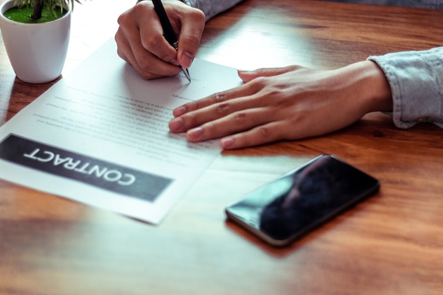 Businessman signing a document in office