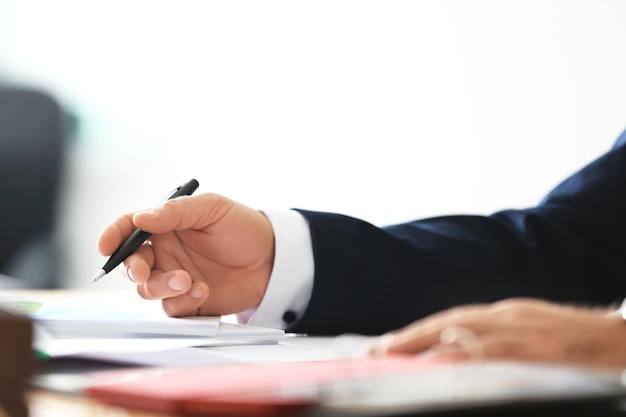 Businessman signing documents in office