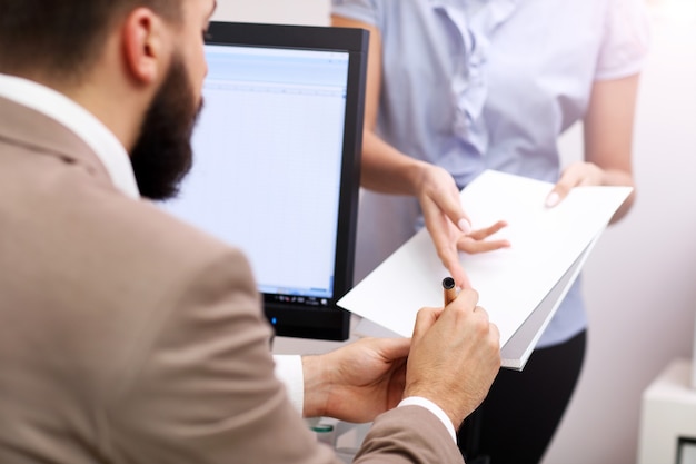 businessman signing documents in office