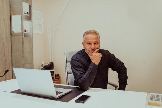 A businessman sits in his and works with paperwork. High quality photo