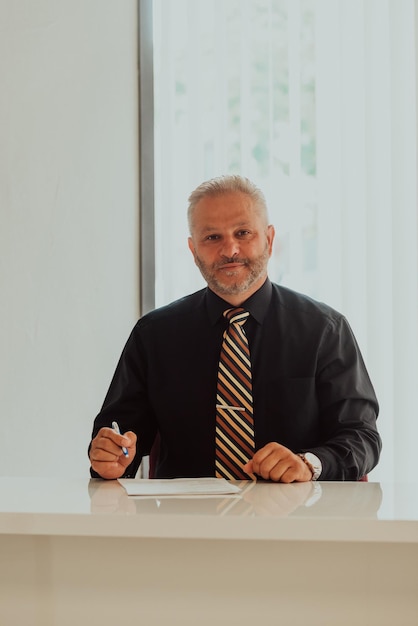 A businessman sits in his and works with paperworkHigh quality photo