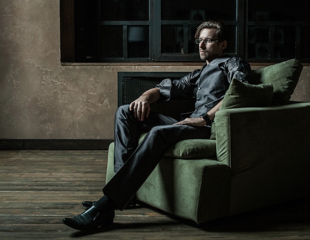 Businessman sitting on an armchair. Fahion man.