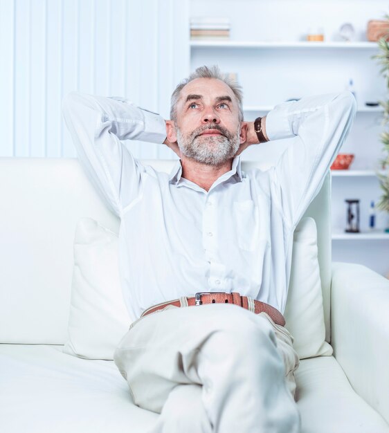 Businessman sitting in a chair the modern office. the photo has a empty space for your text