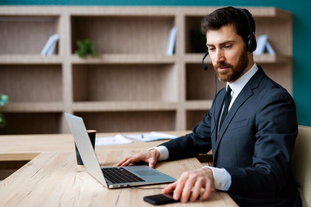 Businessman sitting at computer desk in the office and joining in video conference