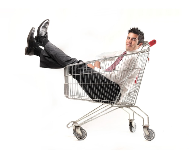 Businessman sitting in a shopping cart