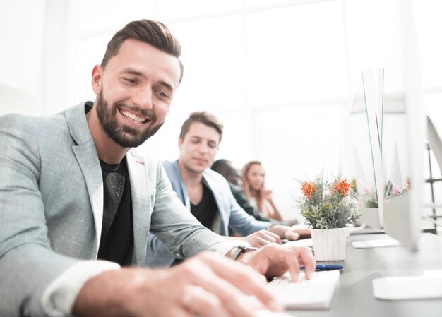 Businessman sitting at a table in the computer room