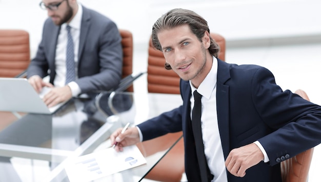 Businessman sitting at a work meeting photo with copy space