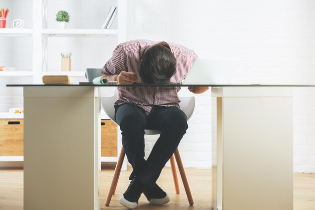 Businessman sleeping on office desk