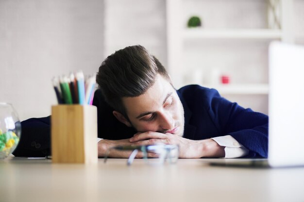 Businessman sleeping on office desk