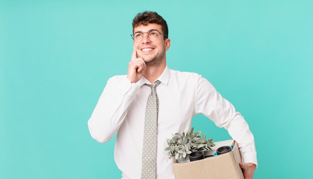 Businessman smiling happily and daydreaming or doubting, looking to the side. dismissal concept